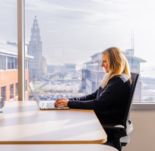 Person working with a view of the Liver Building