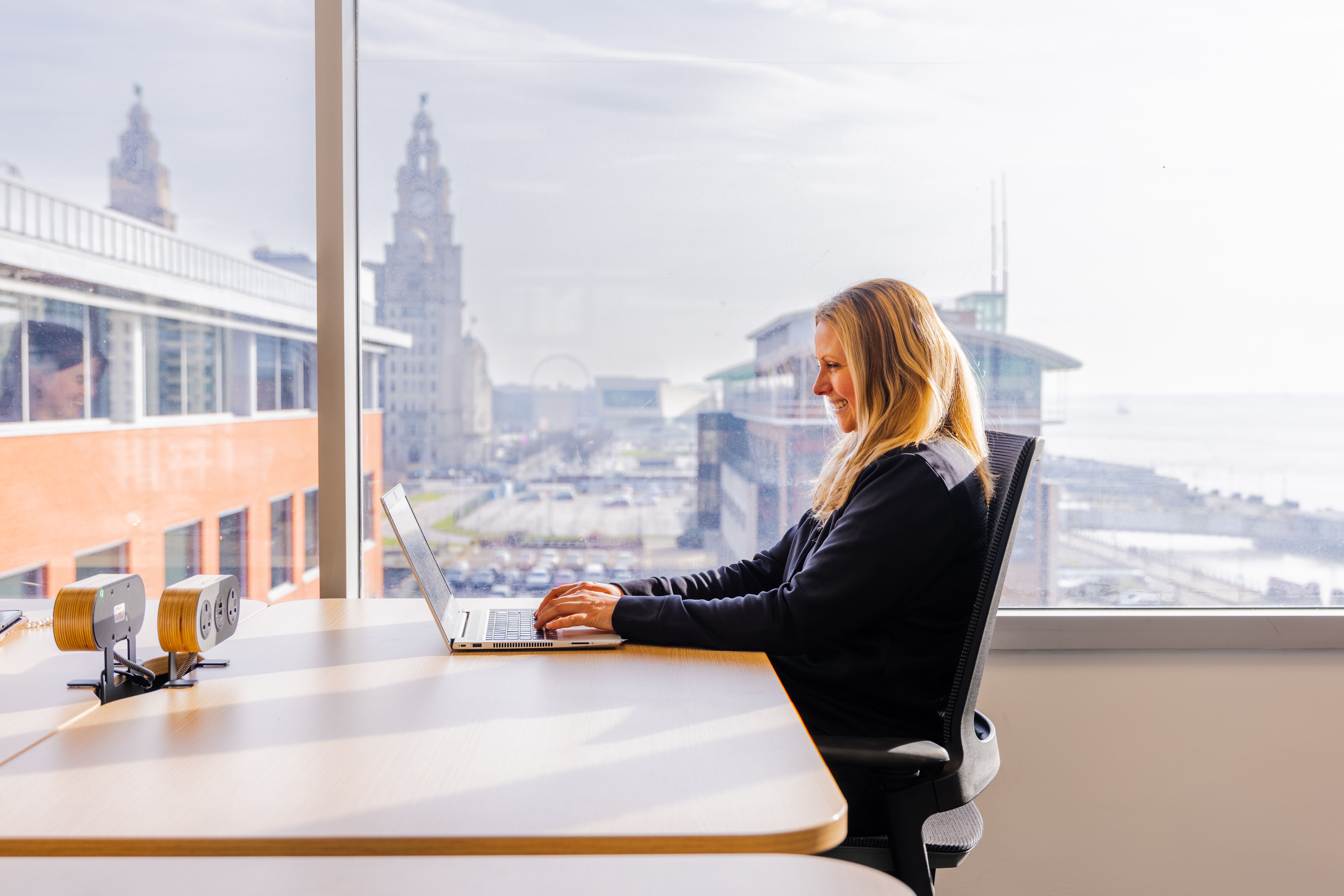 Person working with a view of the Liver Building