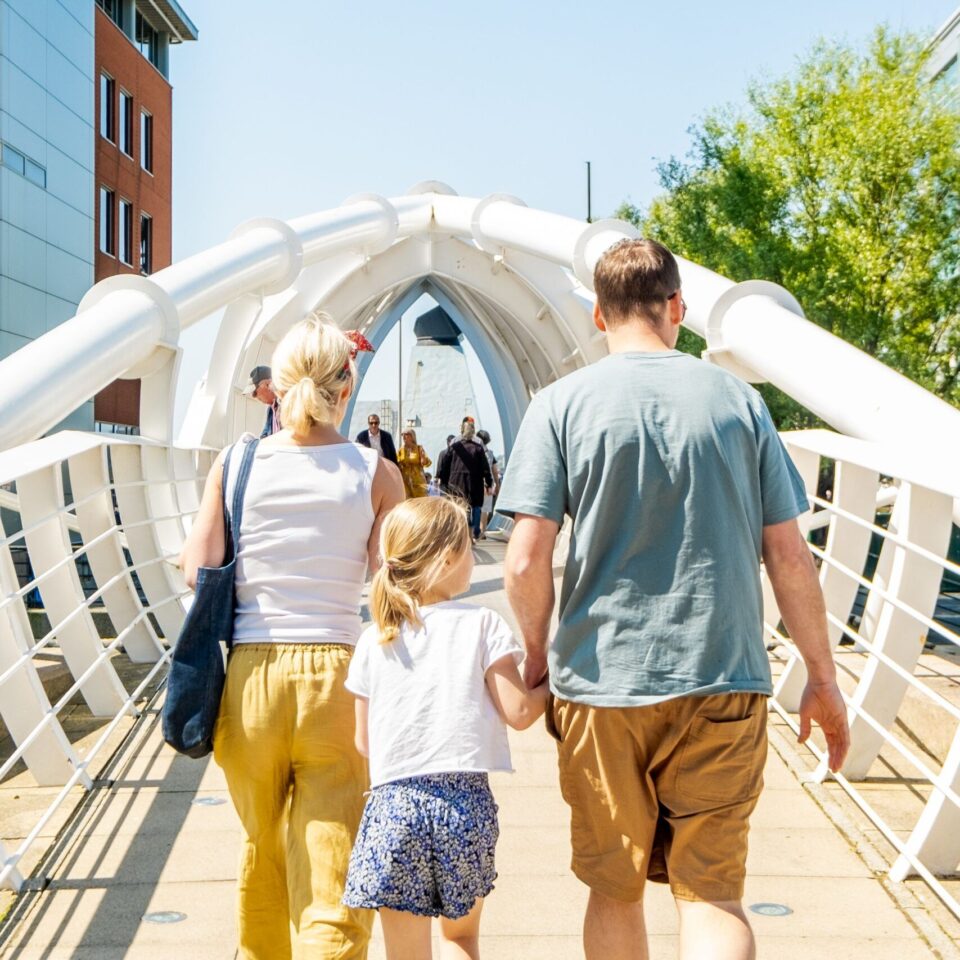 Family crossing bridge at Liverpool Waters