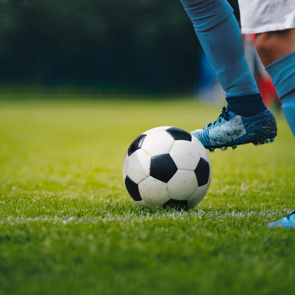 Football player's legs and ball